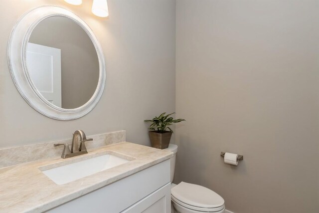 half bath with vanity and toilet