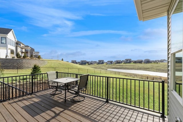 deck with a yard, outdoor dining space, and fence