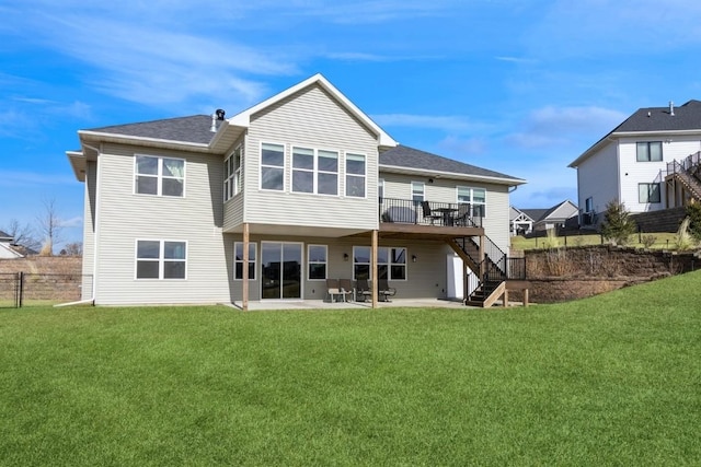 back of property with a patio area, a lawn, fence, and stairs