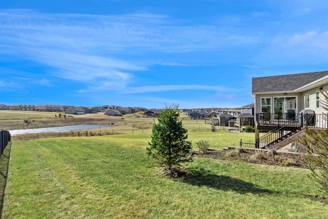 view of yard featuring fence, stairway, and a wooden deck