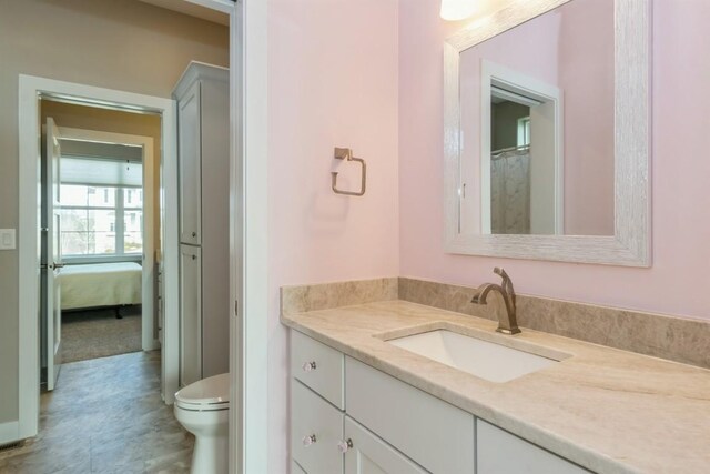 bathroom featuring vanity and toilet