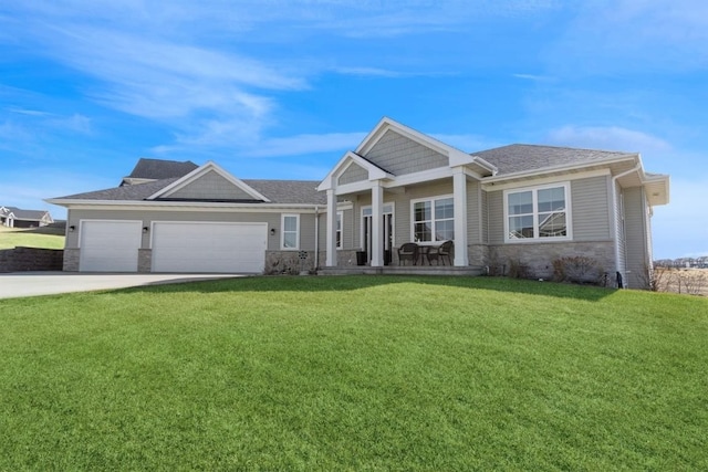 craftsman-style home with a garage, a front yard, stone siding, and concrete driveway