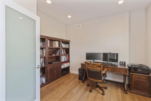 office space featuring baseboards, light wood-style flooring, visible vents, and recessed lighting