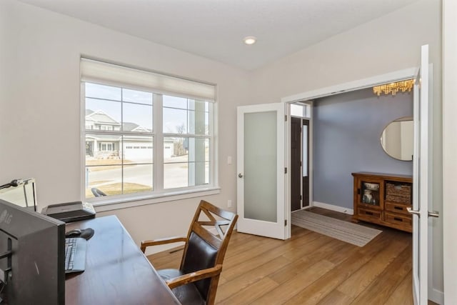 office featuring baseboards and light wood finished floors