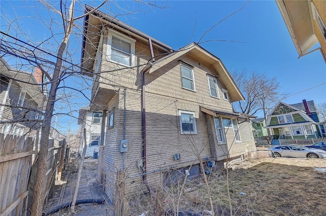 view of side of property featuring fence