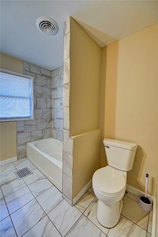 full bathroom featuring toilet, marble finish floor, visible vents, and baseboards