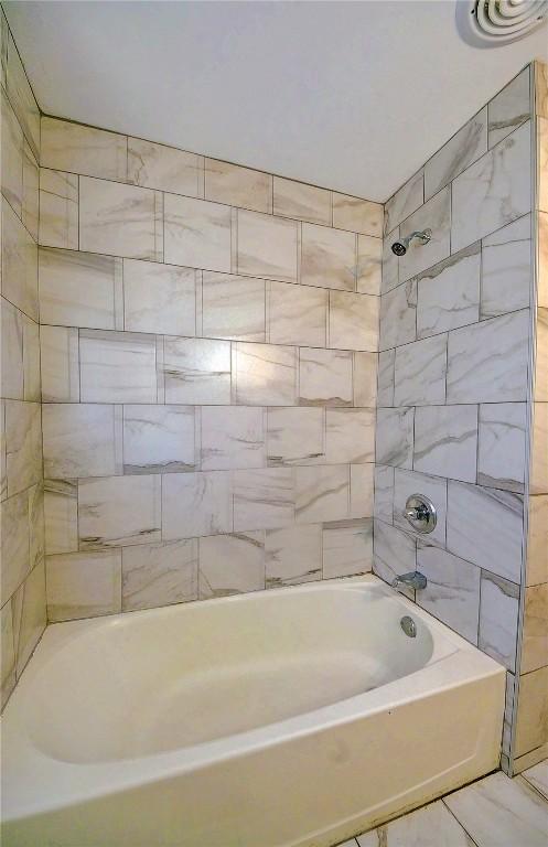 bathroom with shower / tub combination