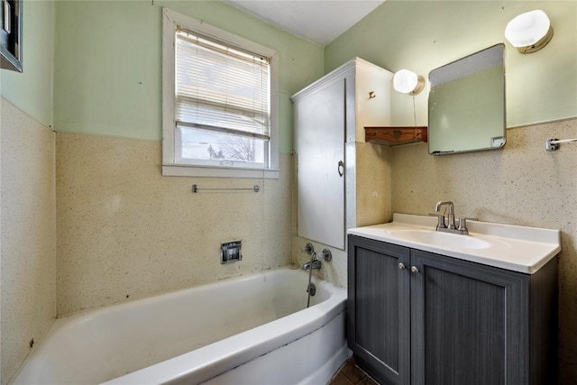 bathroom featuring a tub, wainscoting, and vanity