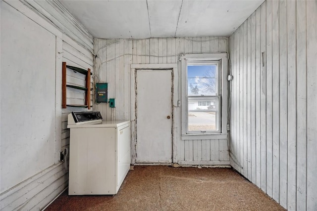 washroom featuring washer / clothes dryer, electric panel, wood walls, and laundry area