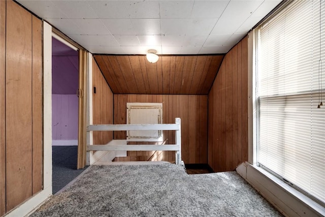 bonus room with vaulted ceiling, carpet, wood ceiling, and wood walls