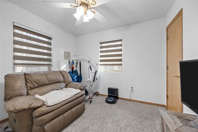 interior space with carpet flooring, a ceiling fan, and baseboards