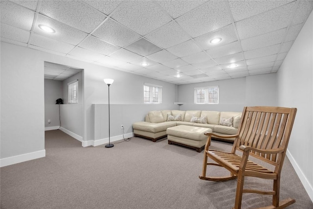 living area featuring carpet, baseboards, a drop ceiling, and recessed lighting