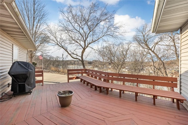 wooden deck featuring a grill