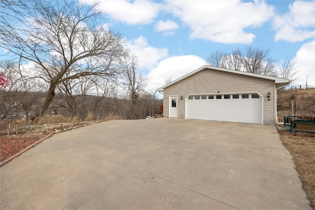 view of home's exterior with a garage and an outbuilding