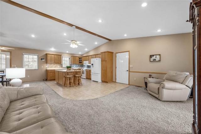 living room with recessed lighting, lofted ceiling with beams, light carpet, ceiling fan, and baseboards