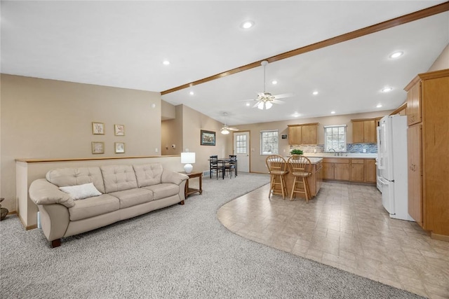 living room featuring vaulted ceiling with beams, recessed lighting, ceiling fan, and light colored carpet