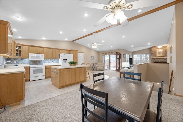 dining room featuring a ceiling fan, recessed lighting, a large fireplace, and vaulted ceiling