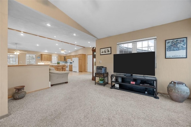 living area featuring a ceiling fan, recessed lighting, light colored carpet, and vaulted ceiling