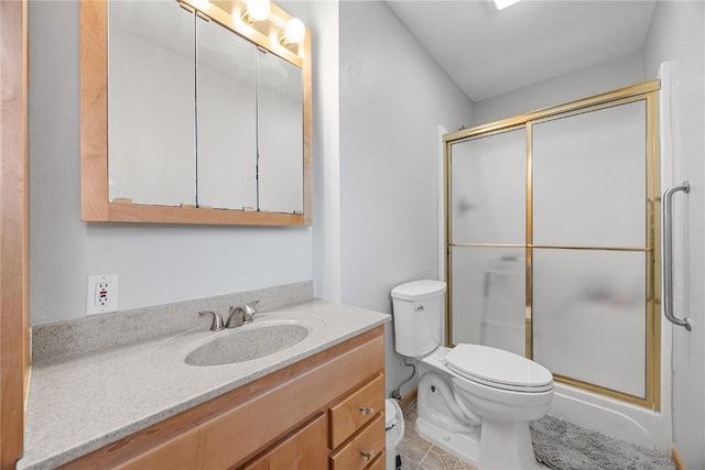 full bathroom with toilet, a stall shower, and vanity