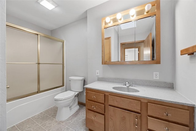full bath with vanity, shower / bath combination with glass door, tile patterned floors, and toilet