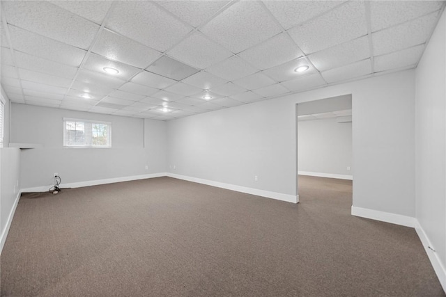 basement featuring recessed lighting, baseboards, a drop ceiling, and dark colored carpet