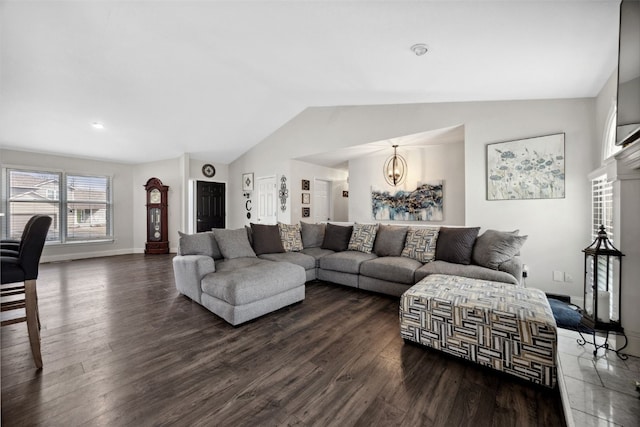 living area with dark wood-style floors, vaulted ceiling, baseboards, and an inviting chandelier