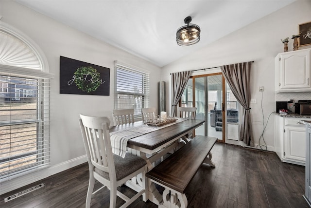 dining area with lofted ceiling, dark wood finished floors, visible vents, and a healthy amount of sunlight