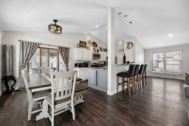 dining space featuring a wealth of natural light, baseboards, vaulted ceiling, and dark wood-type flooring