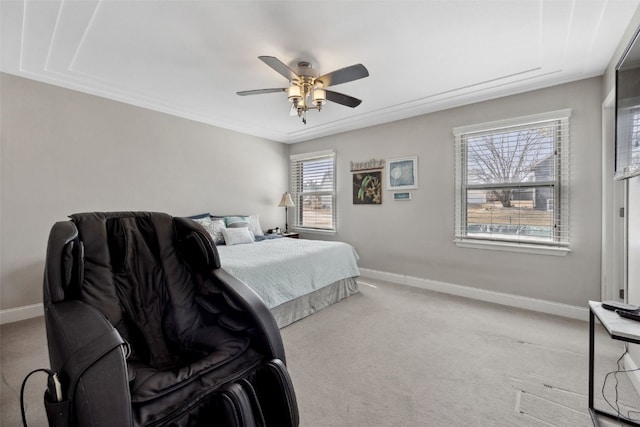 carpeted bedroom with ceiling fan and baseboards