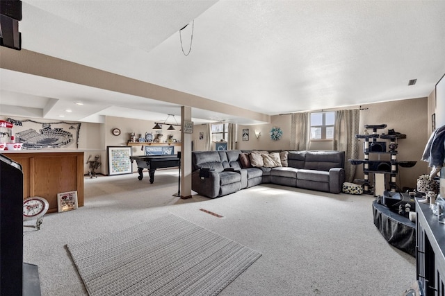 carpeted living area featuring billiards and a textured ceiling