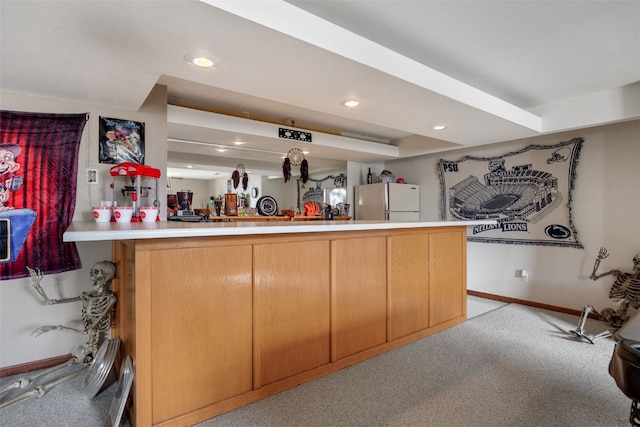 bar featuring light carpet, recessed lighting, freestanding refrigerator, and baseboards