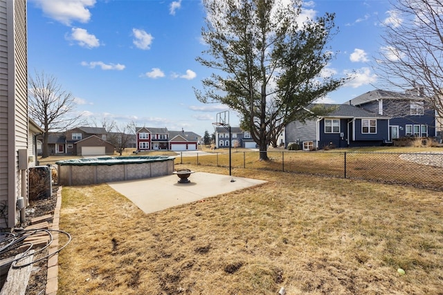 view of yard featuring a patio area, fence private yard, a residential view, and a fenced in pool