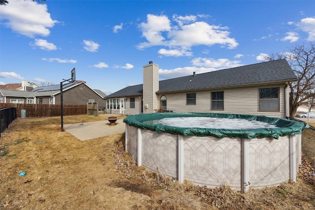 exterior space featuring a fenced in pool, fence, and a patio