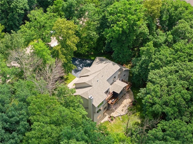 drone / aerial view featuring a wooded view