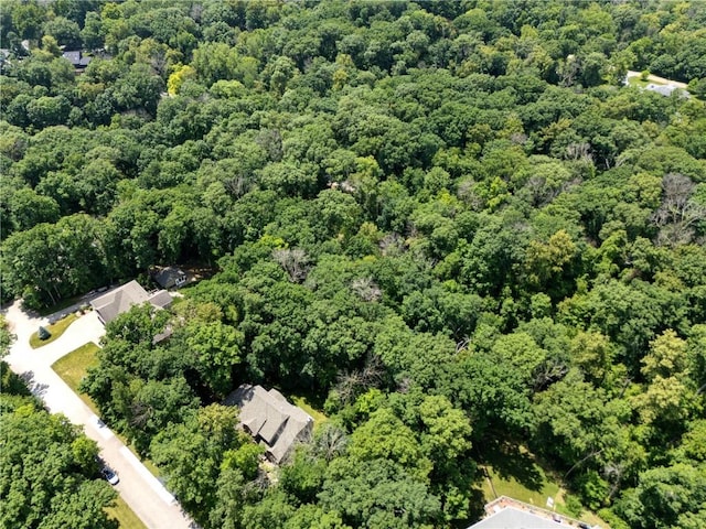 birds eye view of property featuring a wooded view