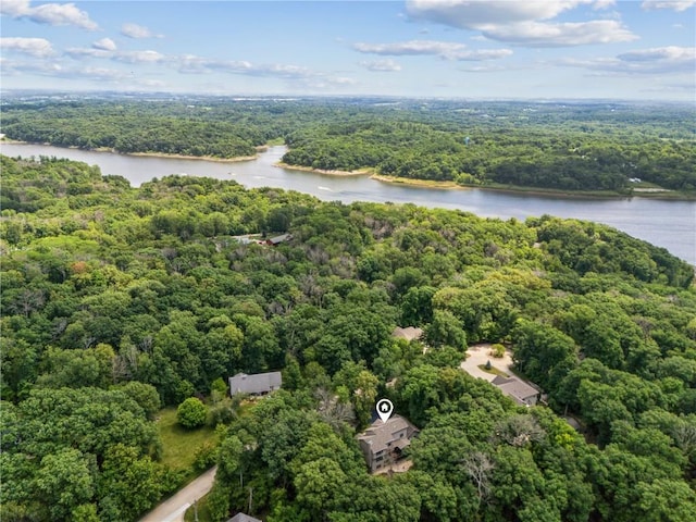 birds eye view of property with a forest view and a water view