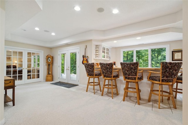 interior space featuring recessed lighting, baseboards, french doors, tile patterned floors, and a dry bar