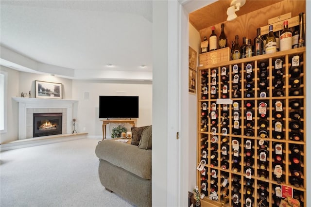 wine area with carpet and a fireplace