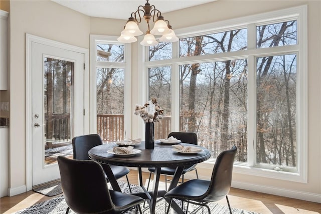 sunroom / solarium featuring a chandelier