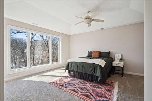 carpeted bedroom with ceiling fan and baseboards