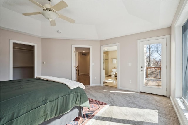 bedroom featuring light carpet, access to exterior, a spacious closet, and a raised ceiling