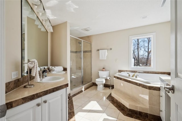 bathroom featuring vanity, a shower stall, toilet, and tile patterned floors