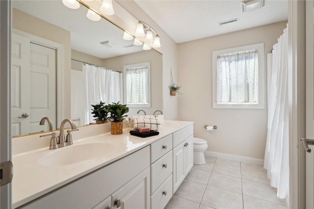 full bathroom with visible vents, toilet, vanity, baseboards, and tile patterned floors