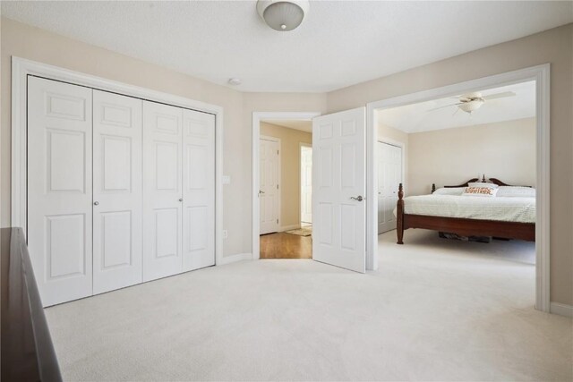 unfurnished bedroom with carpet floors, a closet, and baseboards