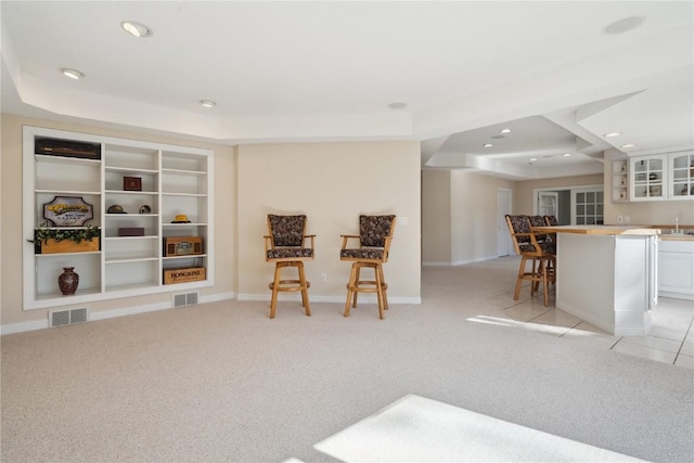 sitting room with recessed lighting, visible vents, baseboards, and light colored carpet