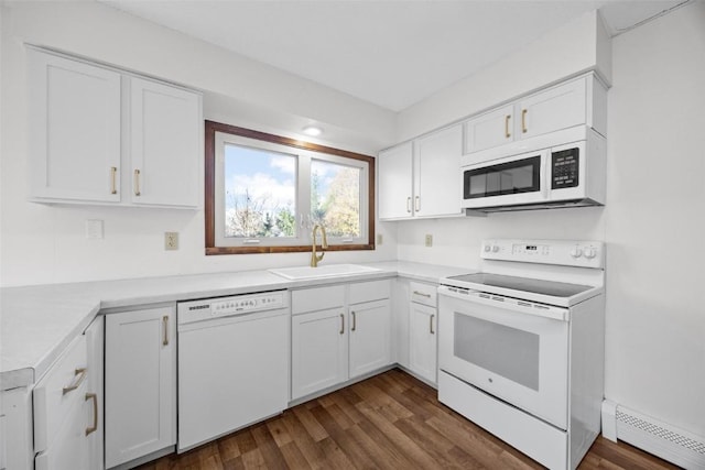 kitchen with a sink, a baseboard heating unit, white appliances, white cabinets, and light countertops