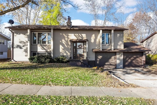 view of front of house featuring a front lawn, a garage, and aphalt driveway