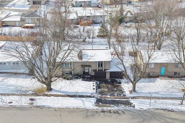 snowy aerial view featuring a residential view