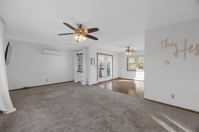 unfurnished living room with a ceiling fan, a wall unit AC, carpet, and baseboards