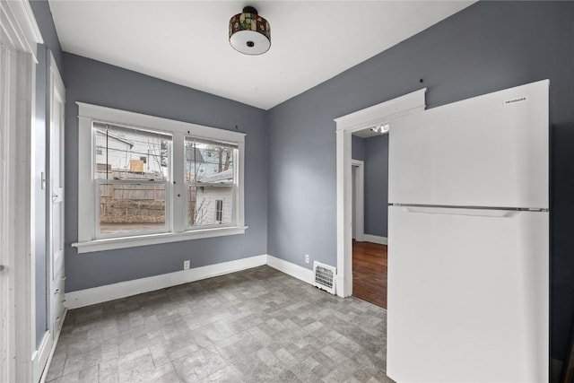 unfurnished dining area featuring visible vents, baseboards, and tile patterned floors